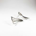 Niki Boli. Silver dissimilar earrings designed with simple elegance. Side view