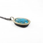 Niki Boli. pendant with oval double turquoise & rutile crystal & 14k gold. Side view