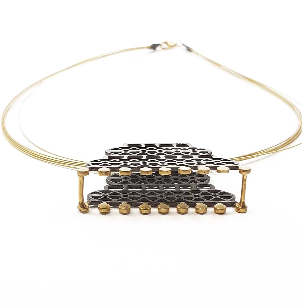 Katerina Malami. Silver necklace with geometric patterns, gold plated and oxidized on steel wires. Frontview