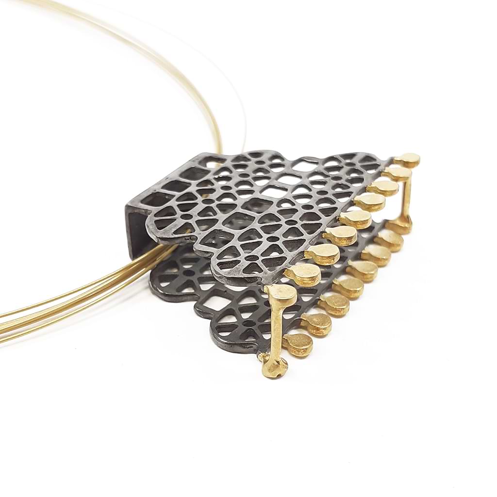 Katerina Malami. Silver necklace with geometric patterns, gold plated and oxidized on steel wires. Detail