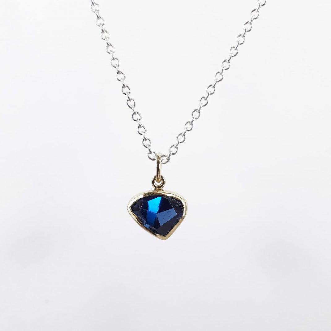 Mary Margoni. Elegant pendant with polygonal London Blue Topaz tied with 18ct gold & silver.