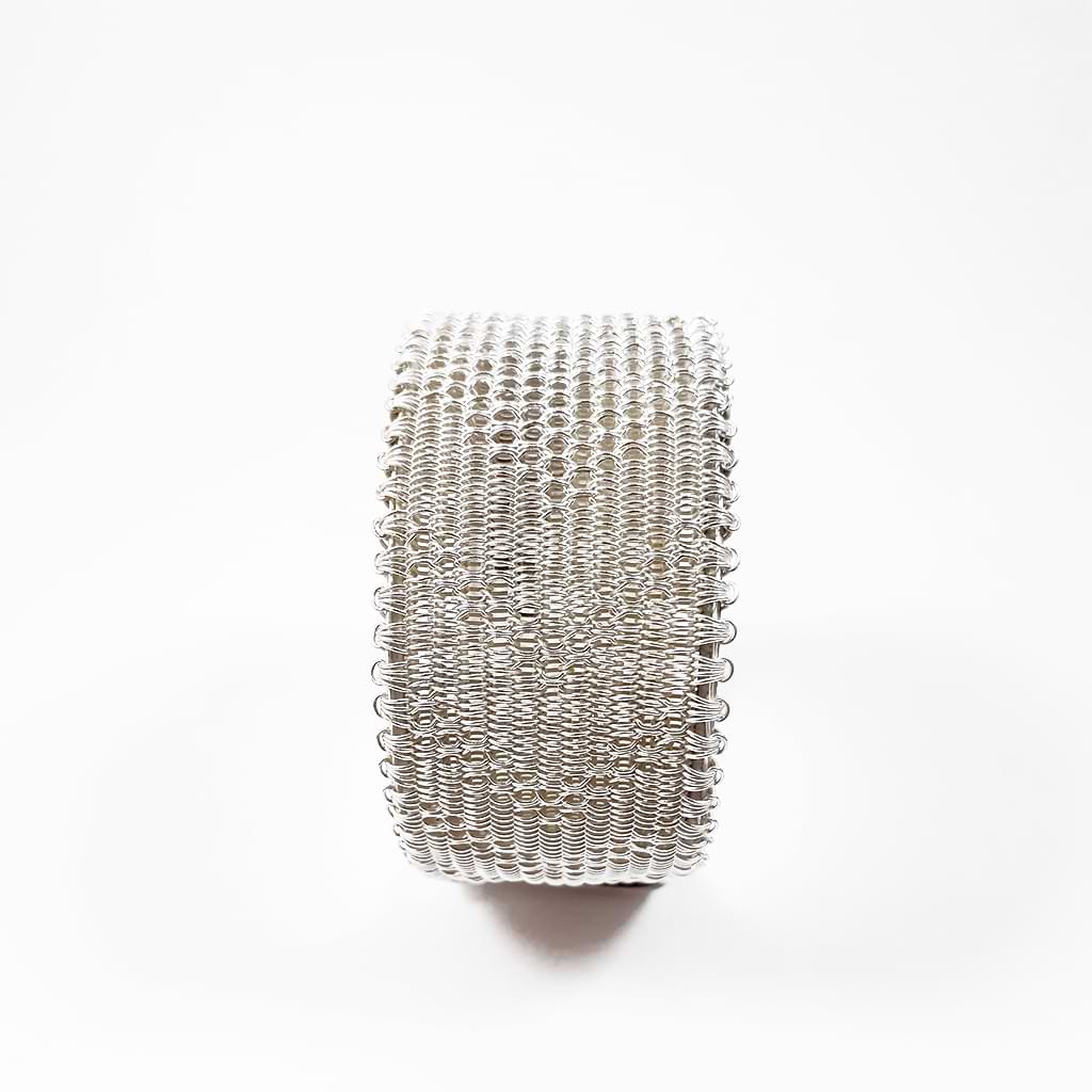 Myrsini Bezourgianni. Wide bracelet made of silver braided by hand with the special maltesing technique. Side view