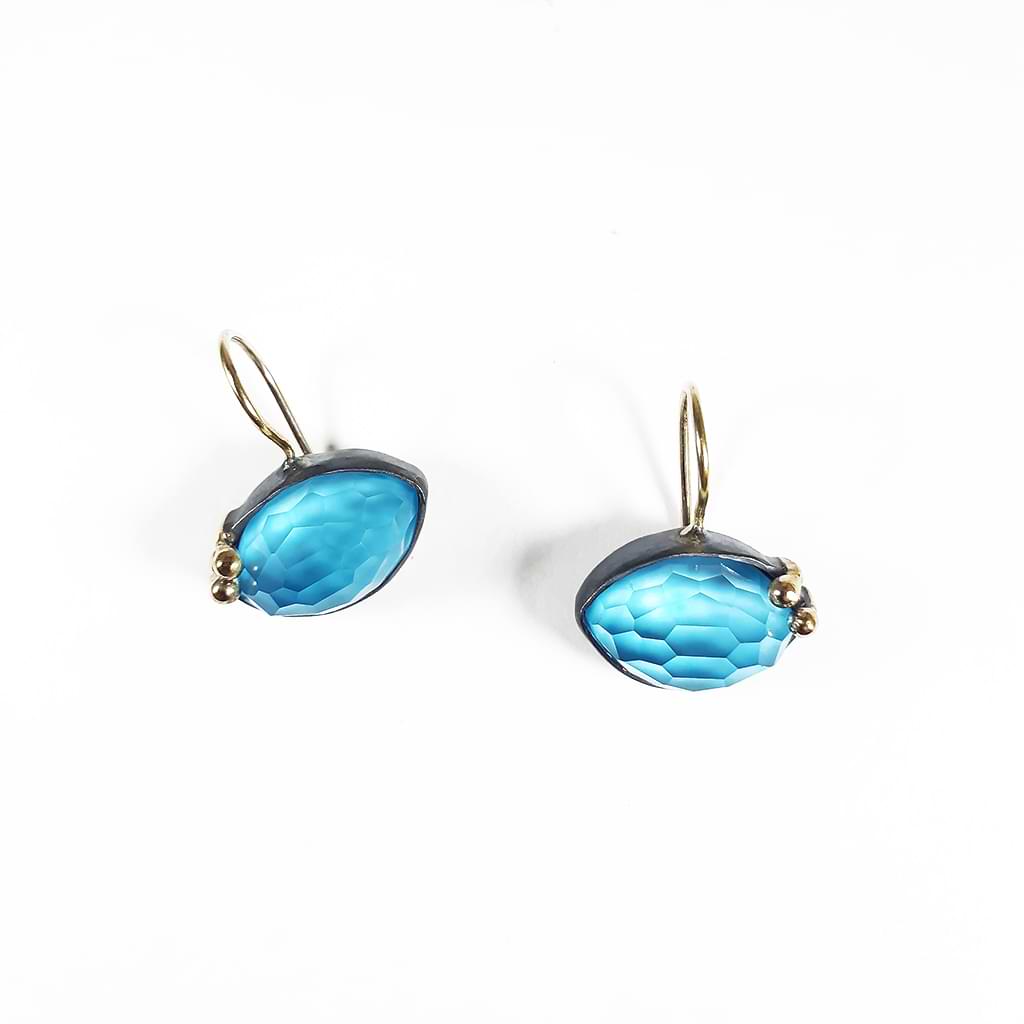 Bright turquoise and crystal doublet earrings, encircled with blackened silver and gold elements.