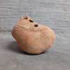 Ceramic vase with earth tones in the shape of a rock. side view