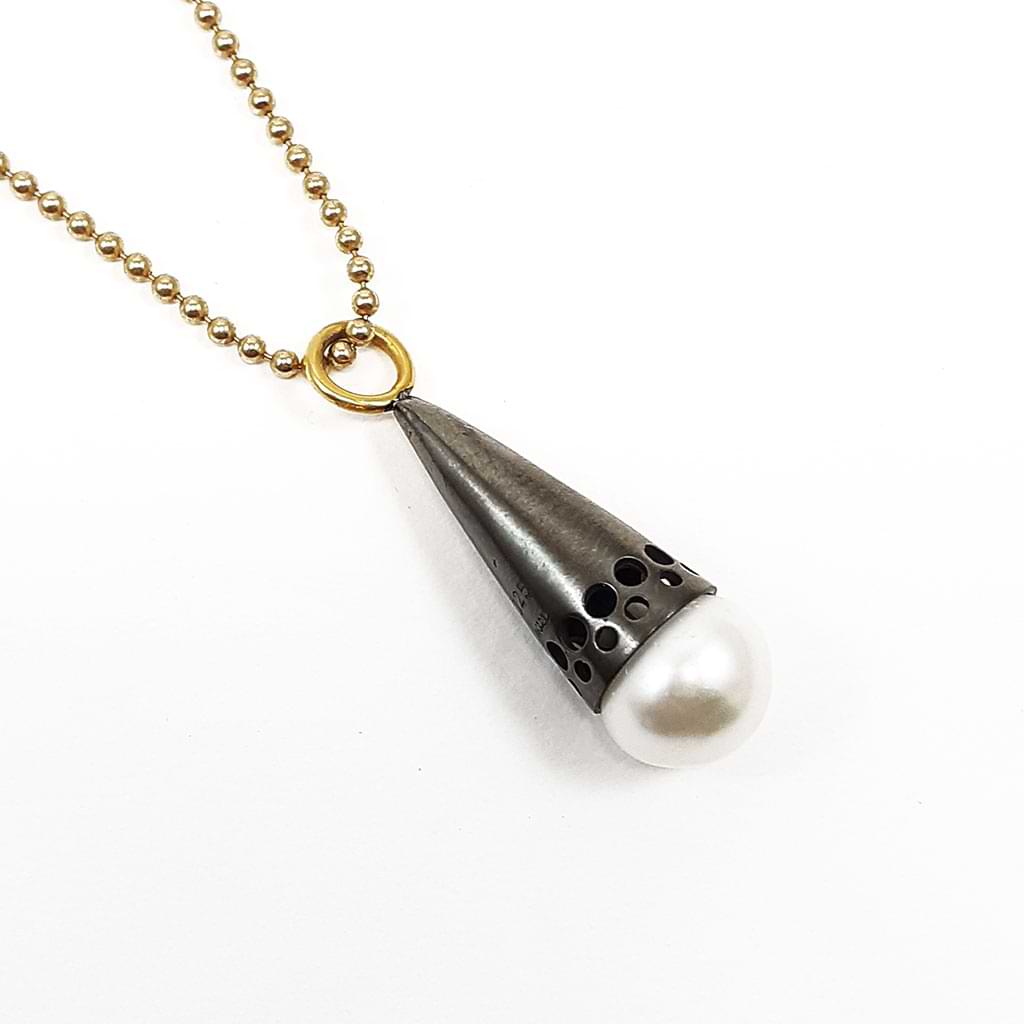 Katerina Malami. Silver pendant with pearl and oxidation in the shape of a cone, gold plated ring and chain.