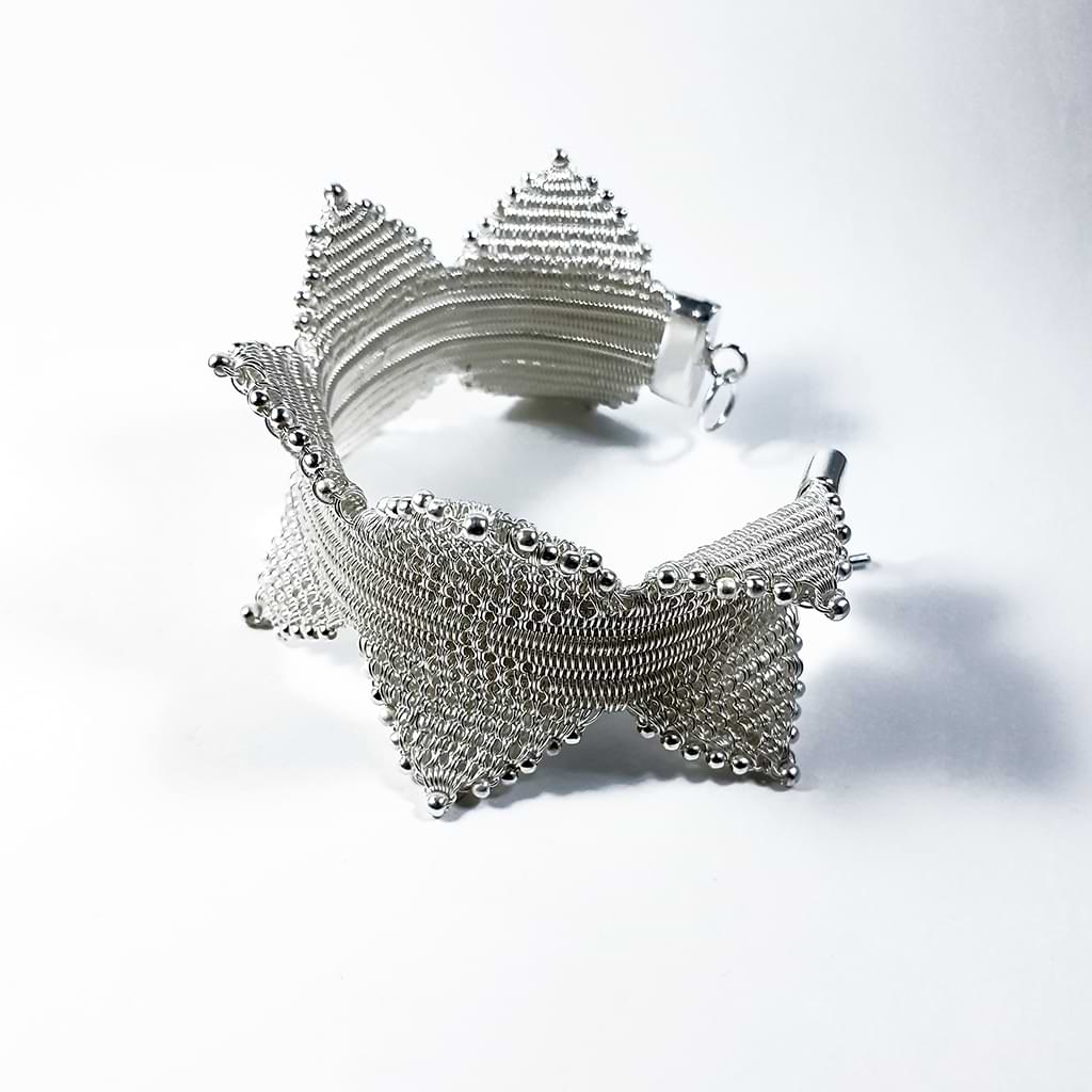 Myrsini Bezourgianni. Silver braided bracelet with spikes. Side view