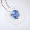 Long round porcelain pendant from the "Blue" series, tied with a leather cord.
